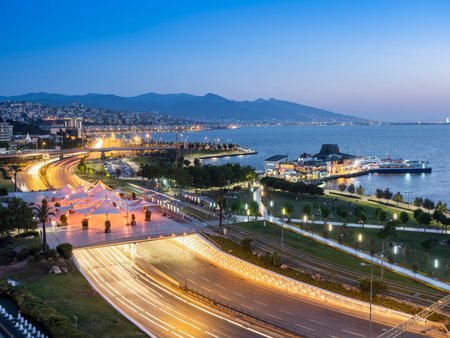 Konak Square street view with old clock tower at sunset. It was built in 1901 and accepted as the official symbol of Izmir City, Turkey.の写真素材