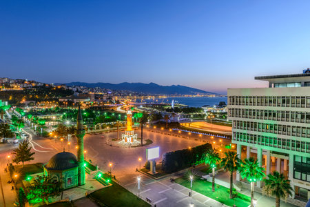 Konak Square street view with old clock tower (Clock Tower) at sunset. It was built in 1901 and accepted as the official symbol of Izmir City, Turkey.の写真素材