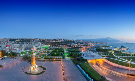 Konak Square street view with old clock tower (Clock Tower) at sunset. It was built in 1901 and accepted as the official symbol of Izmir City, Turkey.の写真素材