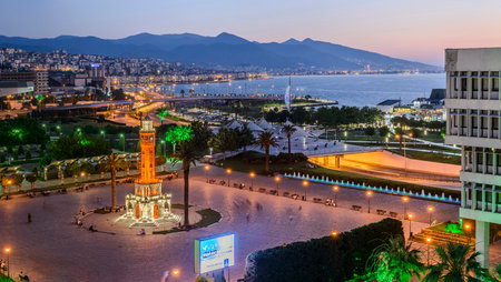 Konak Square street view with old clock tower (Clock Tower) at sunset. It was built in 1901 and accepted as the official symbol of Izmir City, Turkey.の写真素材