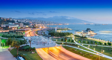 Konak Square street view with old clock tower (Clock Tower) at sunset. It was built in 1901 and accepted as the official symbol of Izmir City, Turkey.の写真素材