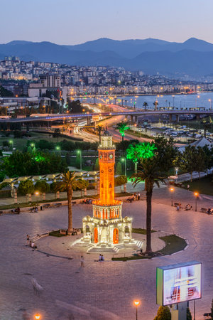 Konak Square street view with old clock tower (Clock Tower) at sunset. It was built in 1901 and accepted as the official symbol of Izmir City, Turkey.の写真素材