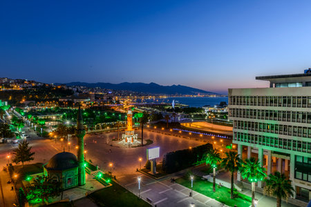 Konak Square street view with old clock tower (Clock Tower) at sunset. It was built in 1901 and accepted as the official symbol of Izmir City, Turkey.の写真素材