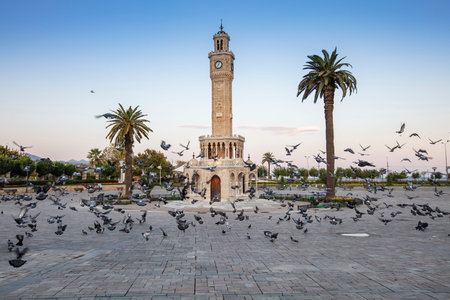 Konak Square street view with old clock tower (Clock Tower) at sunset. It was built in 1901 and...