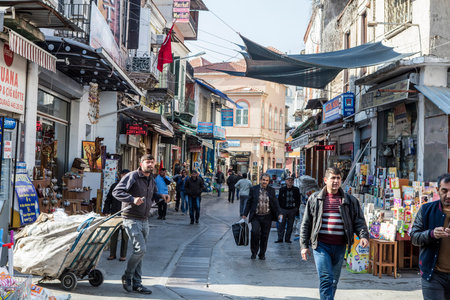 People on the street in Kemeralti district. Kemeralti (Kemeralti Carsisi) is a historical market (bazaar) district of Konak. Izmir, Turkeyの写真素材