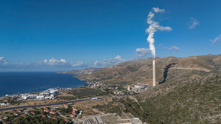 Coal Power Plant Near Coastline and Mountainsの写真素材
