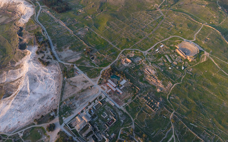 Aerial drone view of Hierapolis Ancient City and the famous Pamukkale travertines in Denizli, Turkey, showing ancient ruins, Roman theater, columns, and scenic landscape from above.の写真素材