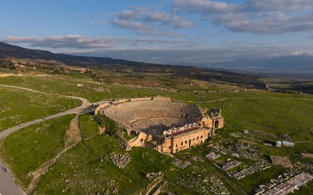 Aerial drone view of Hierapolis Ancient City and the famous Pamukkale travertines in Denizli, Turkey, showing ancient ruins, Roman theater, columns, and scenic landscape from above.の写真素材