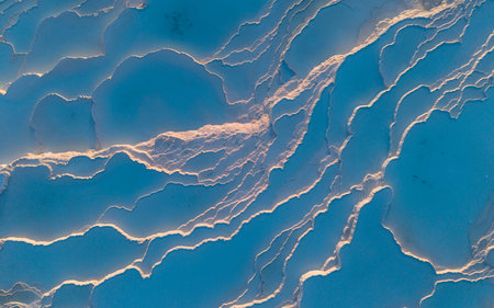 Aerial drone view of the famous Pamukkale travertines and thermal pools in Denizli, Turkey, showing the white calcium terraces, natural formations, and scenic landscape from above.の写真素材