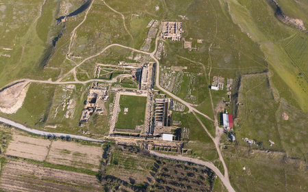 Aerial drone view of Tripolis Ancient City near Buldan in Denizli, Turkey, showing ancient Roman ruins, stone structures, columns, and scenic hillside landscape from above.の写真素材