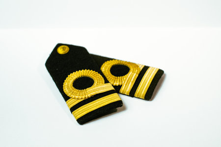 A pair of epaulette gold bar second officers, isolated on whiteの写真素材