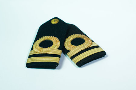 A pair of epaulette gold bar second officers, isolated on white overlapping