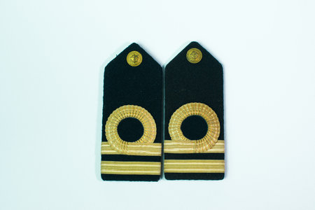 A pair of epaulette gold bar second officers, isolated on white straight side by sideの写真素材