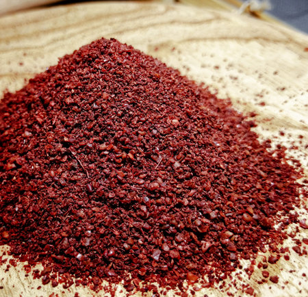 Sumac Powder in Rustic Wooden Bowl Closed up