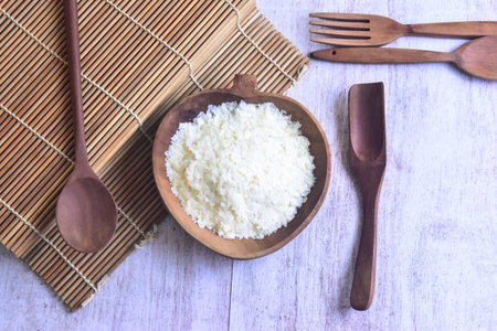 Dry Potato Flakes in a wooden Bowl with spoon and fork aroundの写真素材