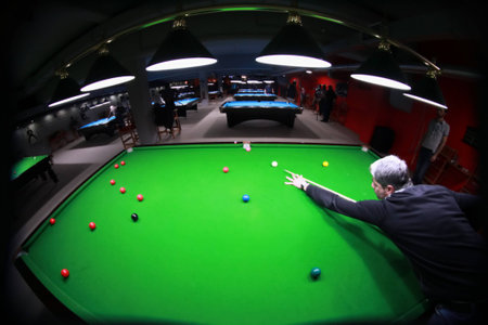 A snooker player shot from above with a fisheye lensの写真素材