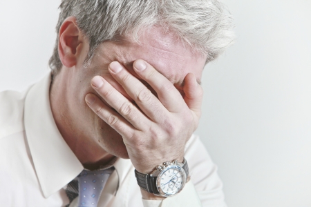 Businessman having head ache as a result of being under pressure   の写真素材