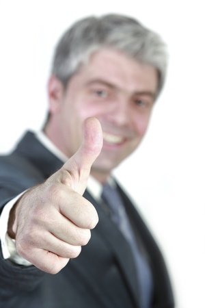Successful young businessman showing thumb up の写真素材