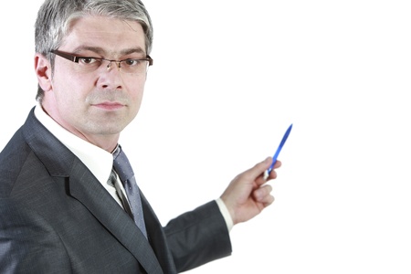 Handsome young businessman isolated on white background pointing his pen to the wall   の写真素材