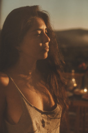 Portrait of attractive woman in t-shirt in sunlight. Sunset outside