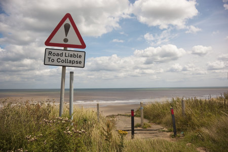 a warning sign near the coast in summerの写真素材