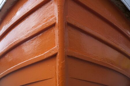 a close up of the prow of a brightly painted traditional small fishing boatの写真素材