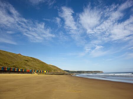 a row of colourful beach huts on the east coast of englandの写真素材