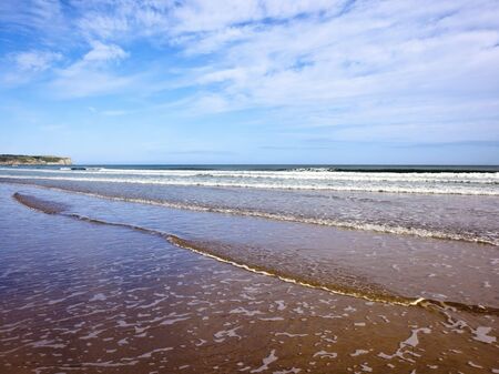 sand sea and sky on the east coast of englandの写真素材