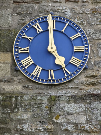 a gilded blue clock on a church tower