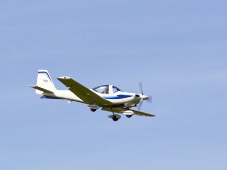 a light aircraft on a training flight in summer under a blue sky