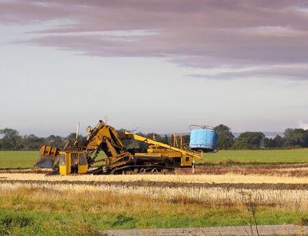 land drainage equipment in a field in summerの写真素材