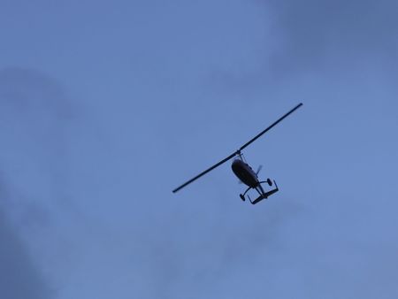 a microlite aircraft flying under a blue skyの写真素材