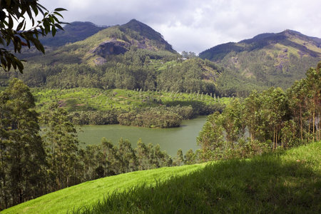 a hilltop view of a lake and some mountains in south india