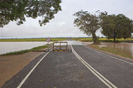 sri lanka landscape with temporary road block and flood waters rising to cut the highway near pottuvilの写真素材