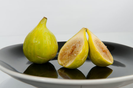 two figs, one cut in half