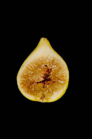 green perfectly sliced in half fig on blackの写真素材