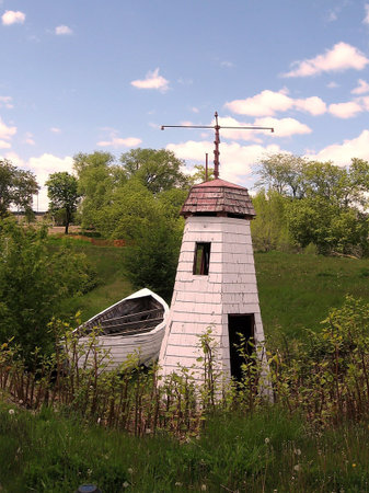 Lighthouse and a boat on bank of lake Ontario in Toronto, Canadaの写真素材