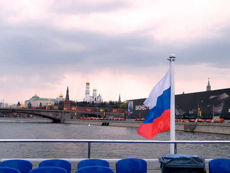 The flag of Russia on the Moscow River in the evening against the backdrop of the Kremlinの写真素材