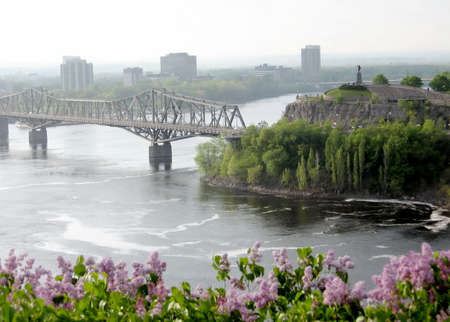 View of Samuel de Champlain statue and Alexandra Bridge Bridge over river in Ottawa, Canadaの写真素材