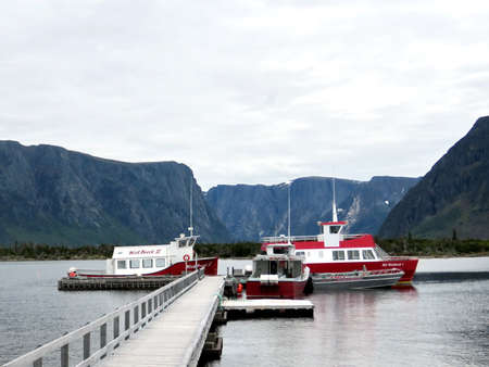 The boats tour the fjords in the distance. Western Brook Pond in Gros Morne National Park, Newfoundland, 13 June 2016 Canadaのeditorial素材