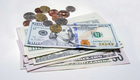 Coins on banknotes with a white backgroundの写真素材