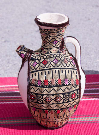 Jug in the bag, decorated with embroideryの写真素材