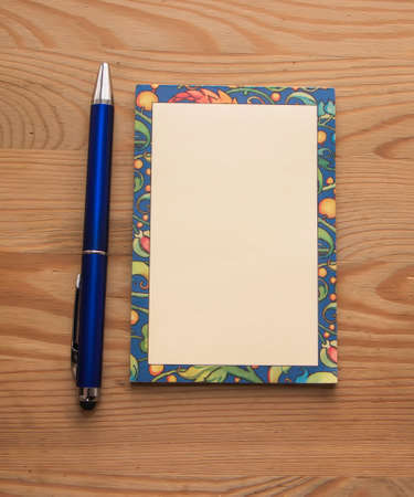 Blank notepad with a penの写真素材