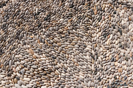 Background of lined white and gray small stonesの写真素材