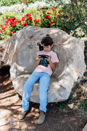 little boy with mobile deviceの写真素材