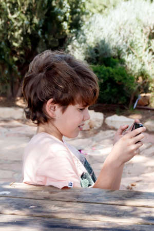 little boy with mobile deviceの写真素材