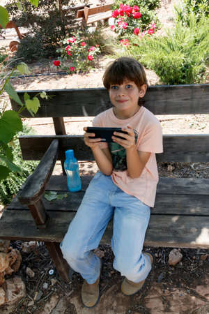 little boy with mobile deviceの写真素材
