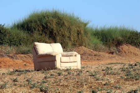 Sofa on the field with harvested cropの写真素材