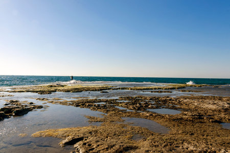 Sea fishing on rocks in tide sea
