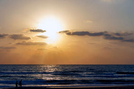 people against the background of the sea sunsetの写真素材